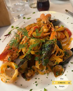Tagliatelle with seafood and Linguine with pistachio pesto and burrata at Ristorante Rio De La Veste, Venice.