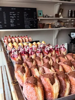 Assorted donuts with strawberry, chocolate, and hazelnut toppings from Eve Bakery.