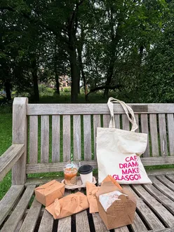 Indoor picnic with @a.pastry's deal: chorizo sandwich, focaccia, pistachio cookie, 2 coffees, and a Glasgow tote bag.