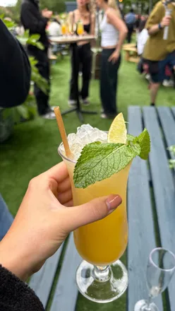 Flight Club Liverpool Sun Terrace with tables, bar, and delicious canapés, located at Chavasse Park, ideal for sunny days.