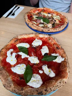 Wood-fired Neapolitan pizza at Cresci Pizzeria York, featuring Diavola Evolution, Capricciosa, and creamy Tiramisu dessert.