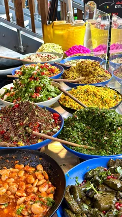 London Southbank street food market with global flavors: NYC chopped cheese, fresh falafel, prawn baos, Indian, Polish, crepes, gozleme.