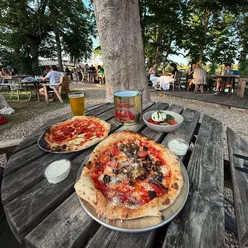 Ndjua and aubergine pizzas with caprese salad at The Medley, Oxford, set in scenic Port Meadow, known for thin crispy bases.