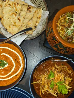 Delicious Indian meal at Urban Choola, Sheffield: amritsari fish, sabudana vada, chicken lollipop, lamb chops, butter chicken, biryani, Salli Boti, garlicky naan, cocktails, and mocktail.
