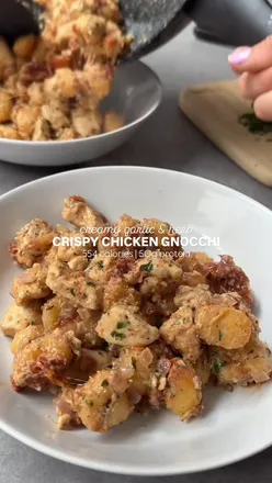 Crispy air fried gnocchi with diced chicken, sundried tomatoes, cream cheese, and mozzarella, garnished with parsley and parmesan.
