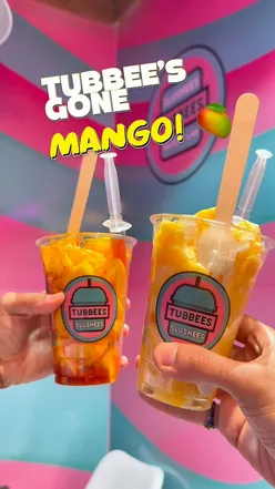Loaded mangoes with hot honey, Tajin, coconut cream, and shavings at Tubbees Desserts, Glasgow. Halal treats available.