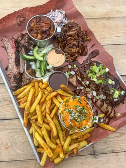 BBQ tray for two at @feastandthefurious with brisket, pulled pork, beef rib, mac and cheese, seasoned fries, and BBQ sauce.
