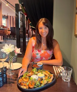 New dishes and decor at The Corner House Cardiff, featuring orange tones, pink marble bartop, British and Mediterranean menu.
