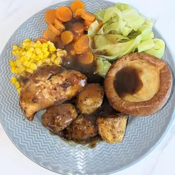 Air fryer mini roast with chicken breasts, potatoes, tinned carrots, sweetcorn, cabbage, and frozen Yorkshire puddings.