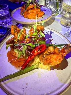 Tamasha Grill Mapperley: diners enjoy vibrant Indian dishes like garlic chilli king prawns, lamb shank, and chicken tikka skewers.
