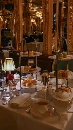 Luxurious afternoon tea at Cafe Royal Grill, Hotel Café Royal, featuring finger sandwiches, scones, cakes, and premium teas in London.
