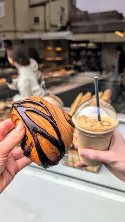 Savour Bake Cafe's handmade treats: Pain aux Chocolate, Smoked Salmon Bagel, Iced Matcha Latte, Cinnamon Bun, Rosemary Focaccia.
