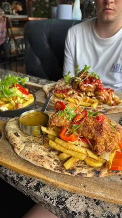 Salt and chilli chicken flatbread, buffalo chicken and chorizo flatbread, hot honey halloumi loaded fries at North Shields Fish Quay during heatwave.