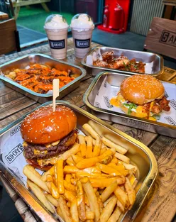 Five Akhis Birmingham: Classic smash burger, blazing bird fried chicken, garlic truffle wings, honey garlic tenders, loaded fries.