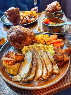 Juicy chicken breast with rich gravy, two homemade Yorkshire puddings, turnip, and cauliflower poppets at Hen and Hops.