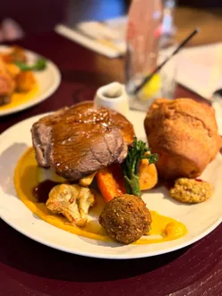 Halal Sunday roast at The Great Chase Restaurant with rosemary chicken, sirloin roast, crispy Yorkshire pudding, and tasty gravy.