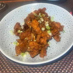 Delicious Thai dishes at Giggling Squid Warwick: crispy duck spring rolls, sweet pork belly, and sticky chicken with addictive sauce.