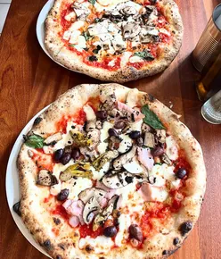 Capricciosa pizza with Prosciutto Cotto, Kalamata olives, Portobello mushrooms, and artichoke hearts at Rudy's Pizza, Birmingham.