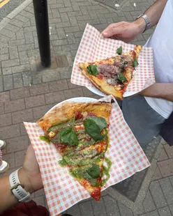 Slices of tapenade, pepperoni, and margherita pizza at Gigi's Pizza Shop in Bristol, known for crispy crust and big flavor.