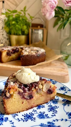Cherry, ricotta, and almond cake on a kitchen counter, inspired by Italian recipes, with a KitchenAid mixer in the background.