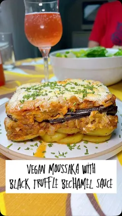 Vegan Greek moussaka with black truffle parmesan, roasted potatoes, grilled aubergines, tomato, mushroom, soy mince, and plant-based bรฉchamel, baked to a golden crust, at a garden birthday party in Nottingham.