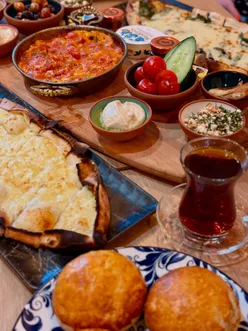 Turkish breakfast for two at Oh My Flatbread in Haymarket, Edinburgh, with breads, dips, spreads, and Turkish tea or coffee.