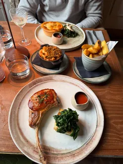 Edinburgh's Badger & Co. summer menu: Pork Tomahawk, Steak Pie, Mac & Cheese, Highland Clava Brie, Sticky Toffee Tea Party, Ciroc cocktails.