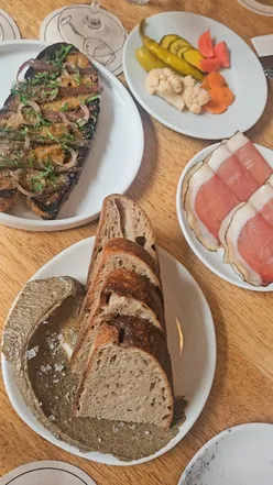 Chill atmosphere at 10 Tib Lane, Manchester with dishes like Holy Grain Sourdough, Corn-fed Chicken, and Affogato with Amaretto.
