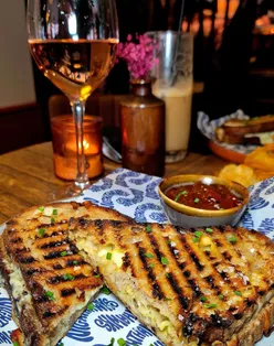 Cheese toastie and tiramisu at Nighthawks Cardiff, known for friendly service and vibrant atmosphere.
