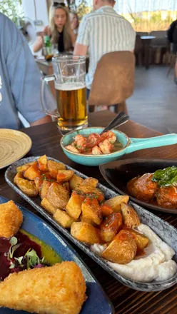 Tapas Ibiza restaurant near San Antonio Beach serves patatas bravas, deep-fried brie, rum lime prawns, Peruvian chicken, and meatballs.