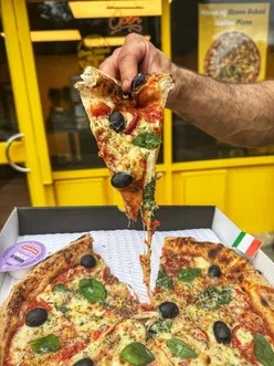 Stone-baked pizza with tandoori chicken, custom mozzarella, Parmesan, chili, spring onion, spinach, and garlic butter fries from Pikka Pizza UK, Sheffield.