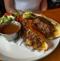 Buffalo chicken waffles, chicken parm ciabatta, Barra Stack, and birria tacos at Roasters Paisley brunch.