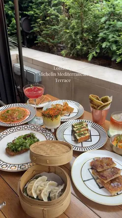 Vibrant al-fresco terrace at Four Seasons London by Michelin chef Yannick Alléno, featuring Middle Eastern, Asian, and North African inspired sharing plates like hummus with coriander oil, wagyu dumplings, and Moroccan lamb tagine.