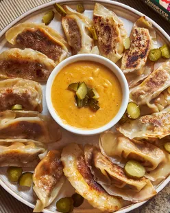 Vegan cheeseburger dumplings with plant-based burger, vegan cheese, onion, gherkins, crispy pan-fried and steamed.