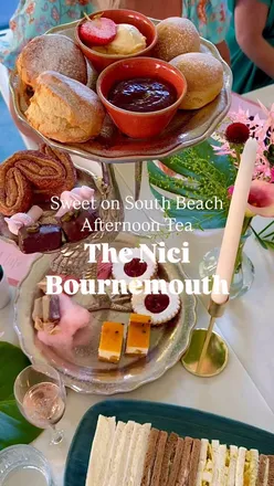 Pink-themed afternoon tea on South Beach terrace with raspberry cakesicles, strawberry shortcake cookies, and pink prosecco.