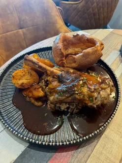 Caribbean Sunday roast at 3 Little Birds Leicester with lamb shank, jerk chicken, Cajun prawns, and salt fish fritters.