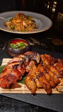 Tynemouth's Hidden Tiger restaurant with floral decor, featuring Pearl of Kowloon cocktail, soft shell crab, and chili fried rice.
