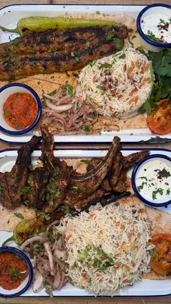 Authentic Turkish dishes at Baltic Market's Çat Kapi, featuring lamb chops, adana kebab, chicken wings, sucuk, and grilled halloumi.