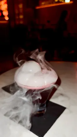 Creative cocktails with dry ice and wagyu beef at Hokus Pokus Kings Cross, offering a sexy vibe and fancy bar snacks.