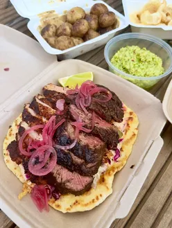 Patagonia food truck in Merthyr Tydfil serving charcoal-grilled beef and pork fillet with homemade sides and guacamole.