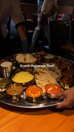 Grand Maharaja Thali at Shahe Gosforth with Dal Makhni, lamb curry, naan, mango lassi, and more flavorful Indian dishes.