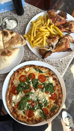 Whole rotisserie chicken at Uncle Ali's in Harlesden, London, priced at £14, known for the best rotisserie chicken.