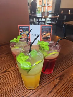 Halal food at Tribez Steak Grill in Bolton: bites platter, Tribez special salad, African burger, and peri peri chicken.