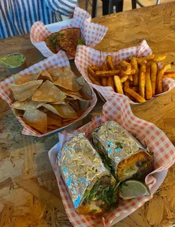 Beef burrito with nachos, cheese dip, Coca Cola, and Birria tacos with peri peri fries, guacamole, and Fanta at Loco Lime, Bournemouth.