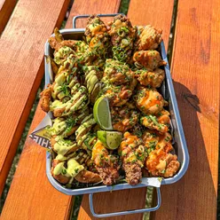 Richie's Shrimps seafood street food: golden calamari, spicy Cajun shrimp, Poโ Boys, lobster tails, and loaded nachos.