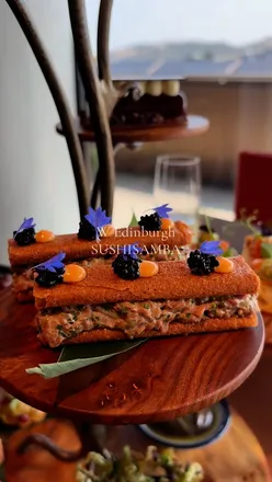 Enjoying afternoon tea at Sushi Samba, W Hotel Edinburgh, with city views, delicious bites, and a spa retreat.