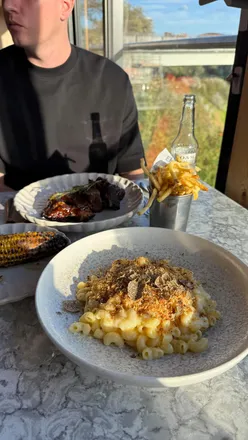 Guests enjoying an Americana menu at Ember in Sunderland with dishes like BBQ beef ribs and truffle mac and cheese.