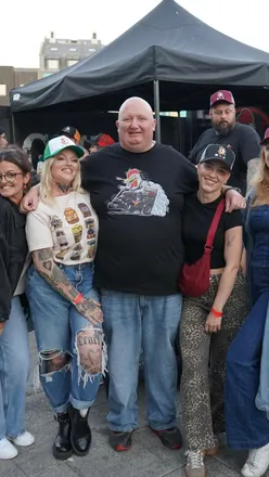 Guests enjoying hot wings at Gurt Wings' Wingfest preview launch party in Bristol, with laughter and great vibes.