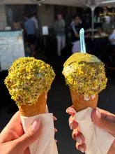 Enjoying rich vanilla bean ice cream with pistachio toppings at La Pistacherie, Paris, near the Eiffel Tower.