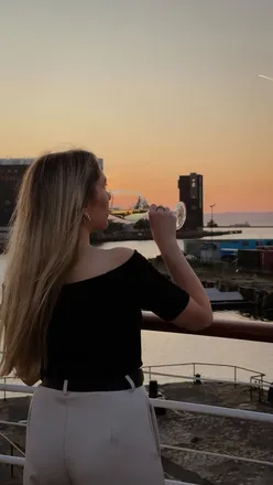 Couple enjoying dinner at the floating Lighthouse restaurant in Leith, Edinburgh, with stunning waterfront views.